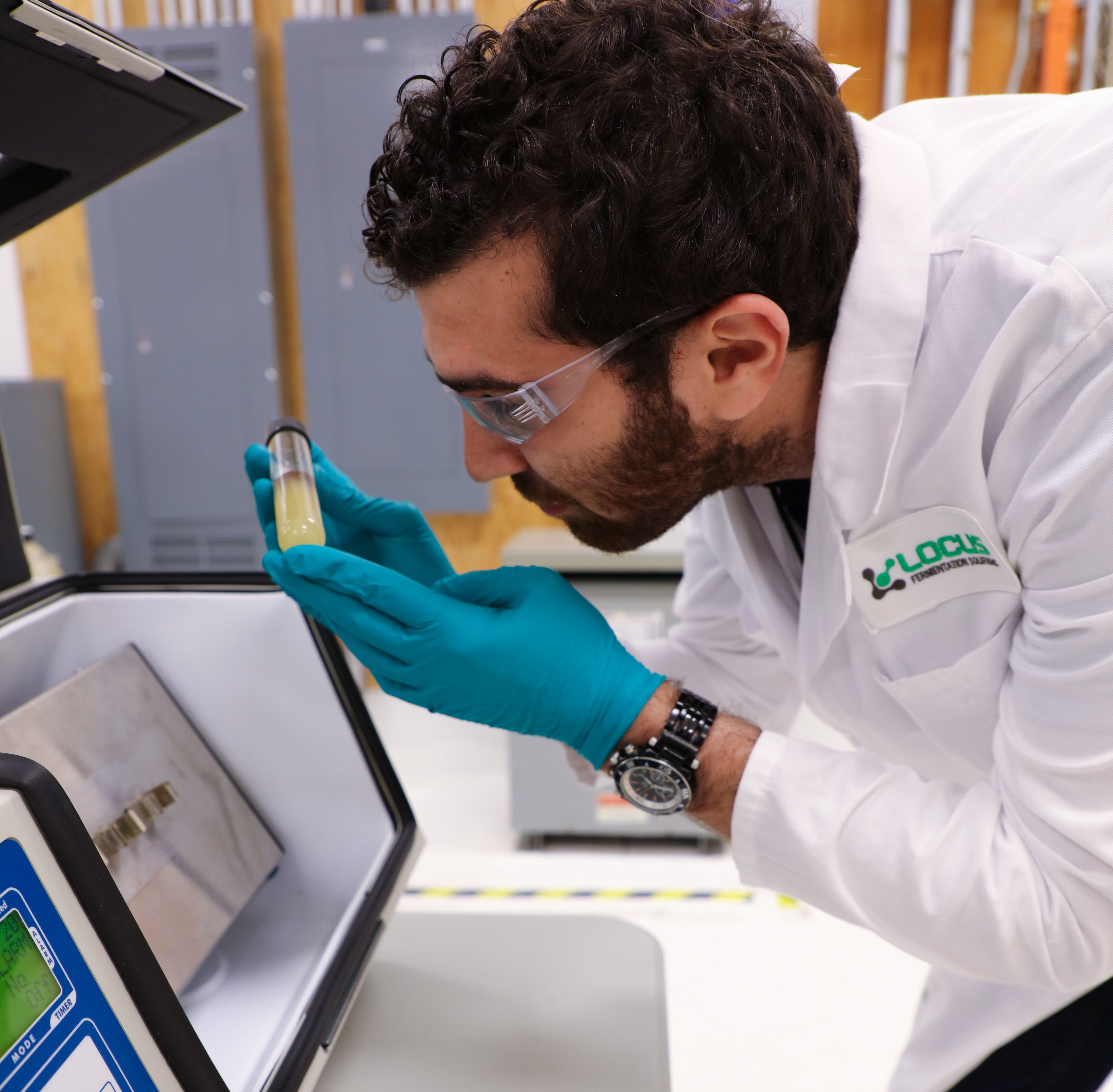 Lab Technician inspecting biosurfactant formulation